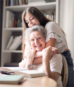 Granddaughter hugging her grandmother